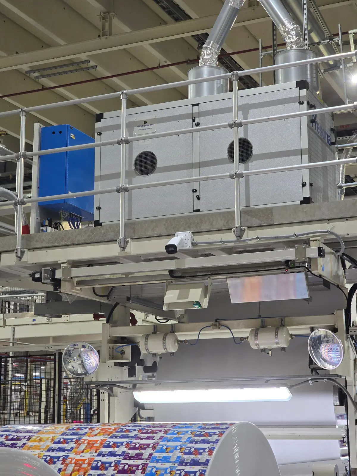 Bullet camera mounted under a platform above a production line