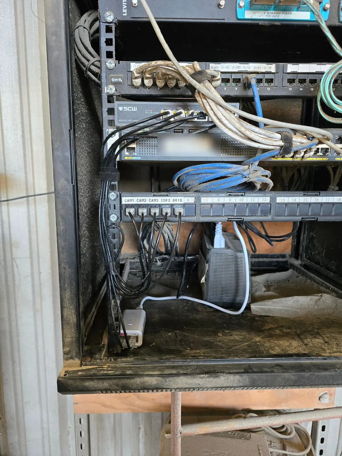 Network cabinet with labeled patch panels and a PoE switch
