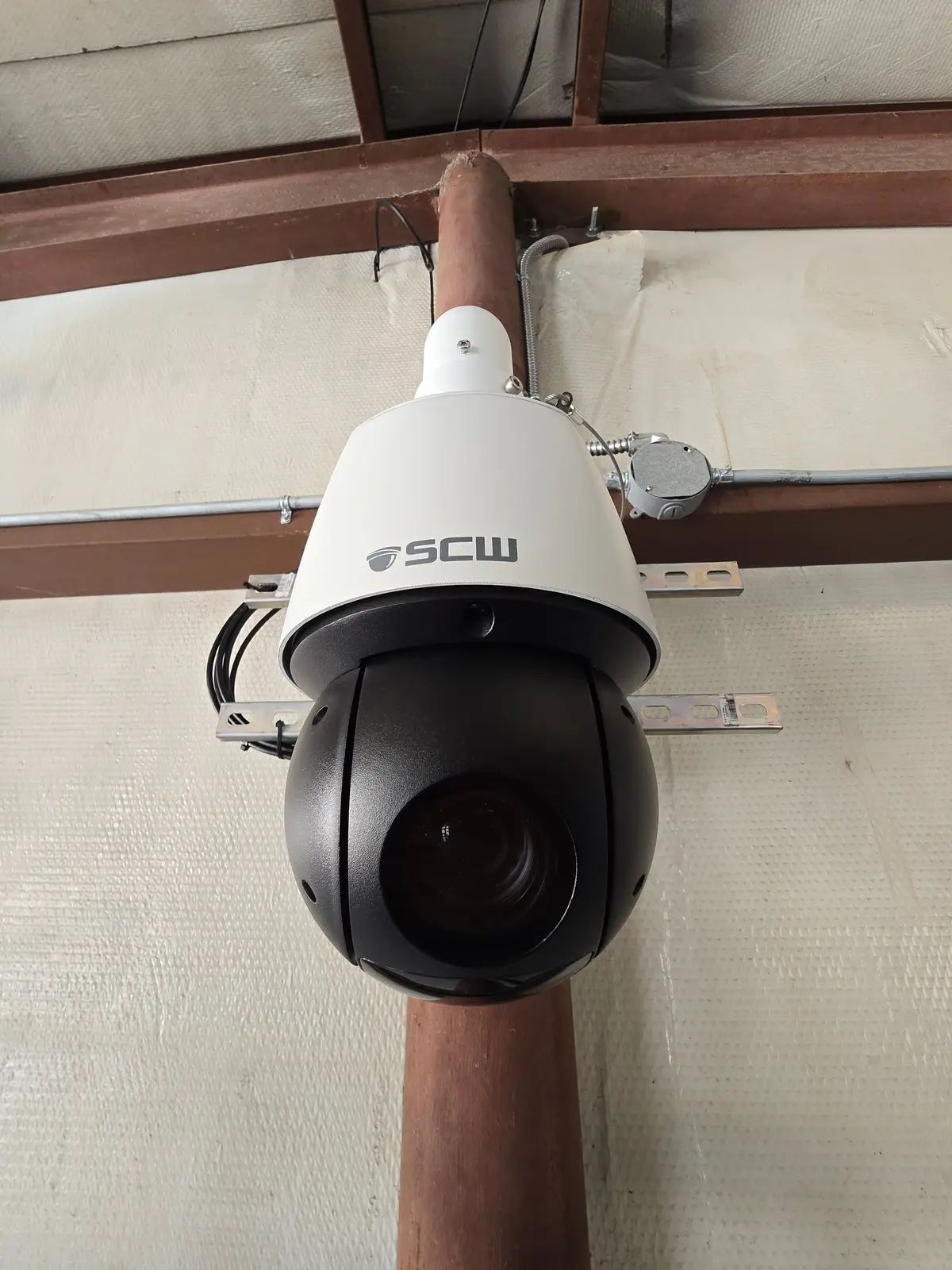 PTZ camera mounted to a vertical pipe with a junction box